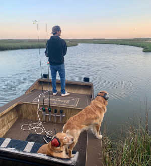 Shiner and Nattie watching Capt. James catch fish!